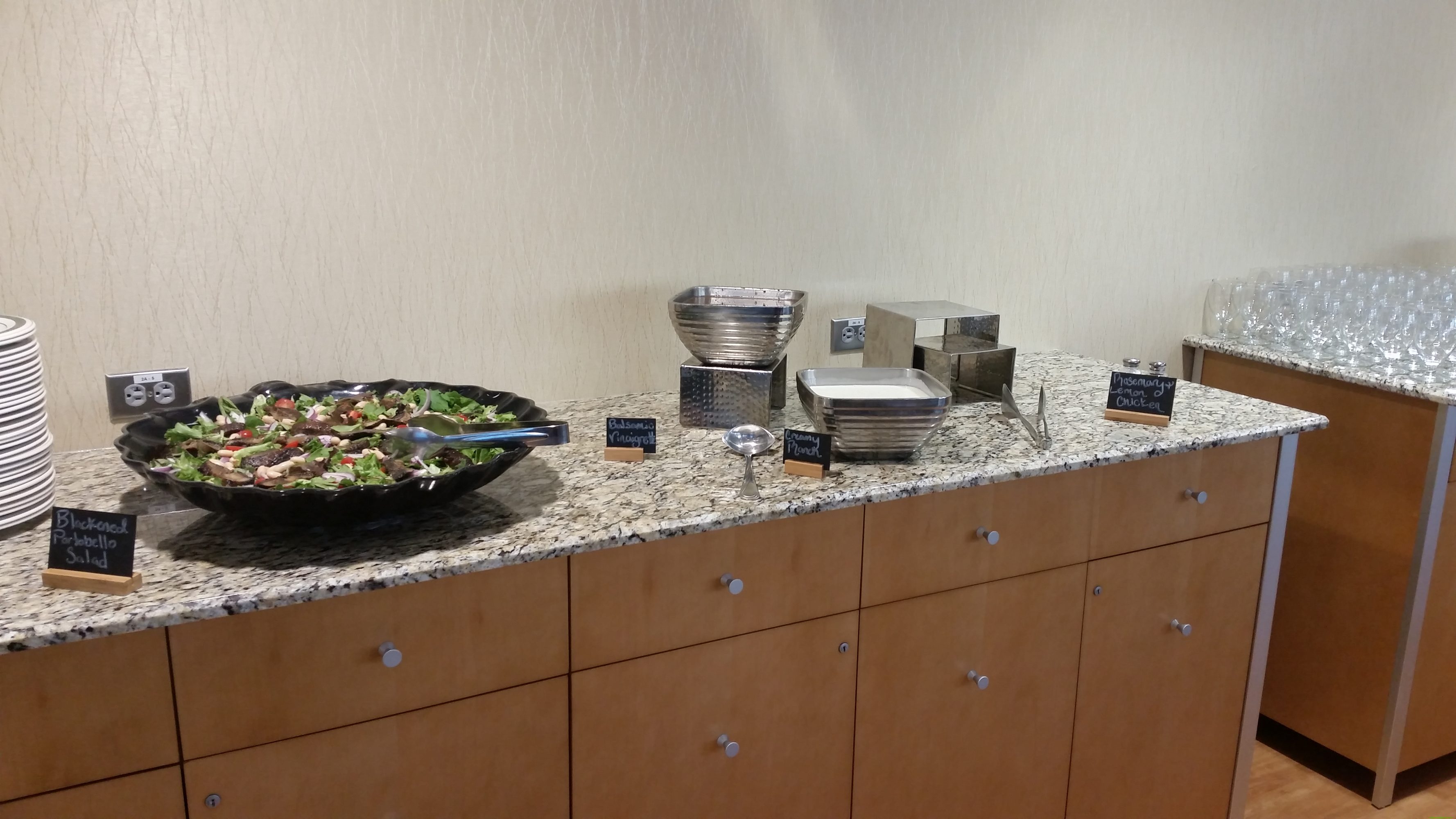 A buffet table set with food and beverages.