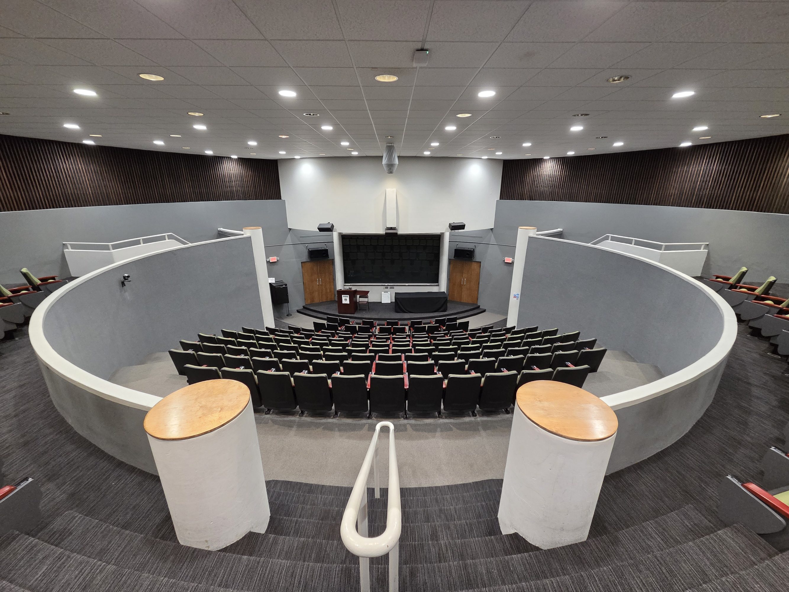 An image of a blank auditorium space with rounded walls.