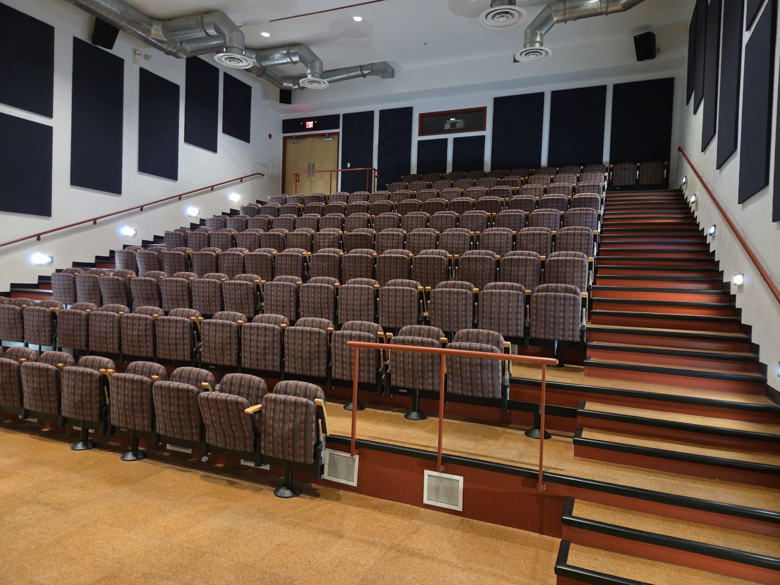 An image of an empty room facing tiered chairs.